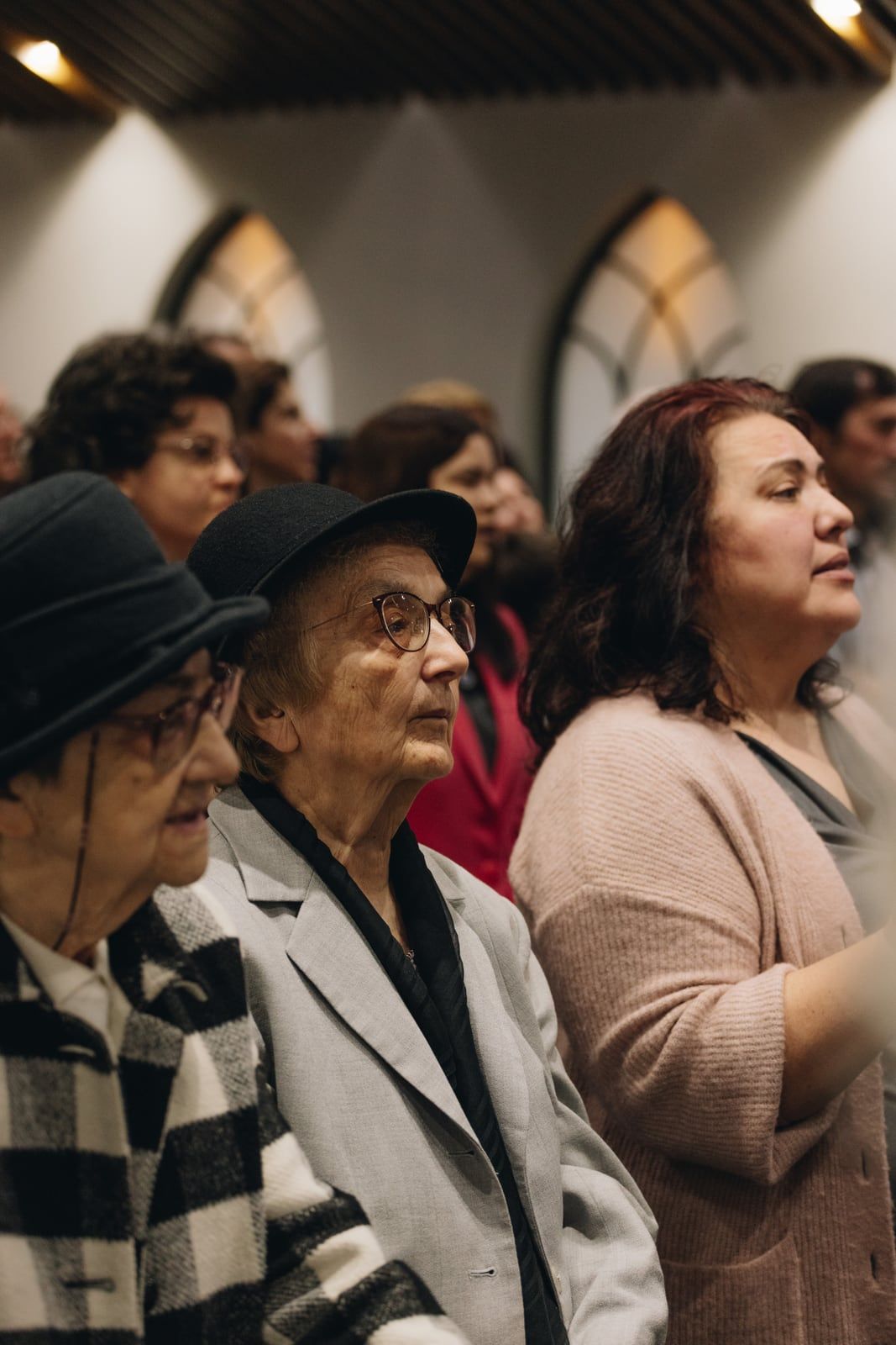Femei vârstnice din biserică ascultând în timpul slujbei
